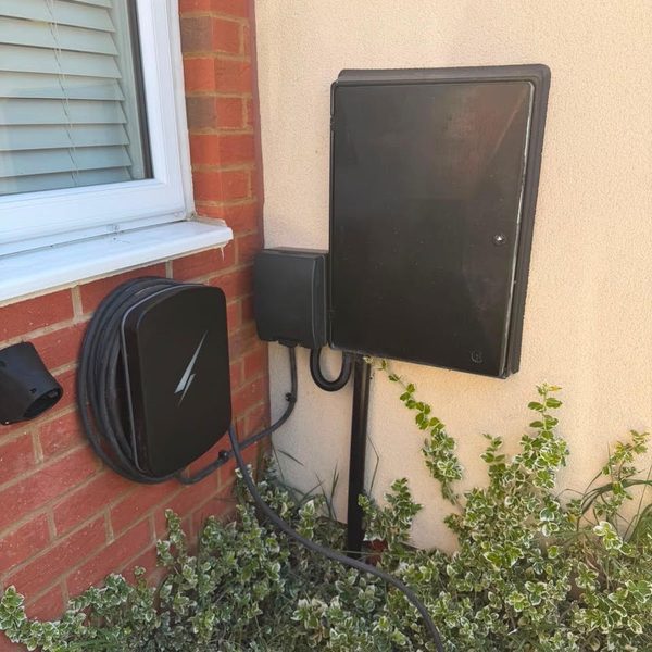 EV charger fitted beside the meter boxes of a home